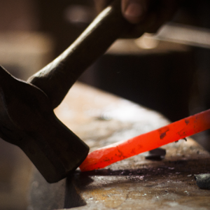 IHEA Blacksmith shaping hot metal with a hammer