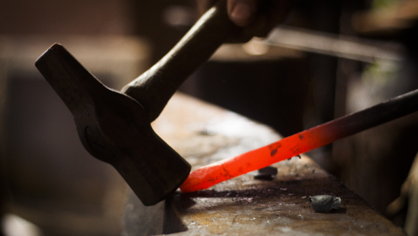 IHEA Blacksmith shaping hot metal with a hammer